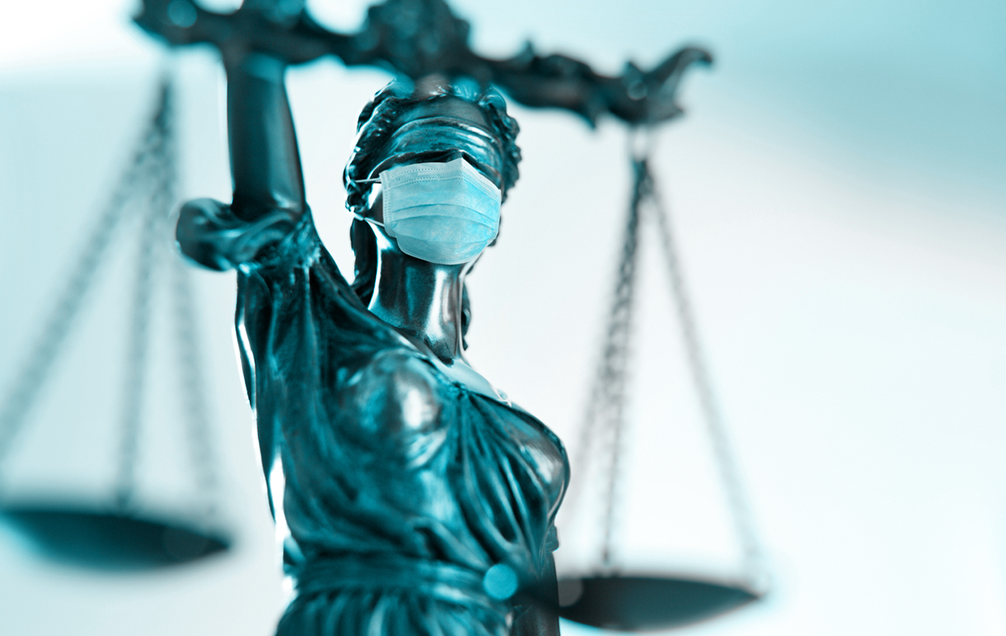 covid lawsuit scales of justice wearing mask